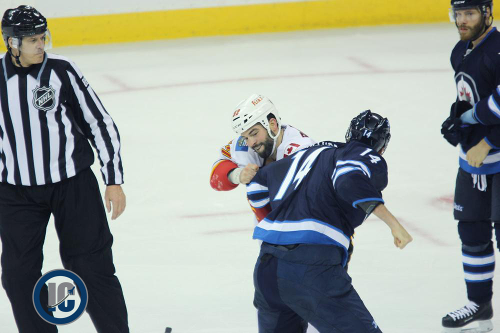 Peluso fights Bollig with Raffl looking on