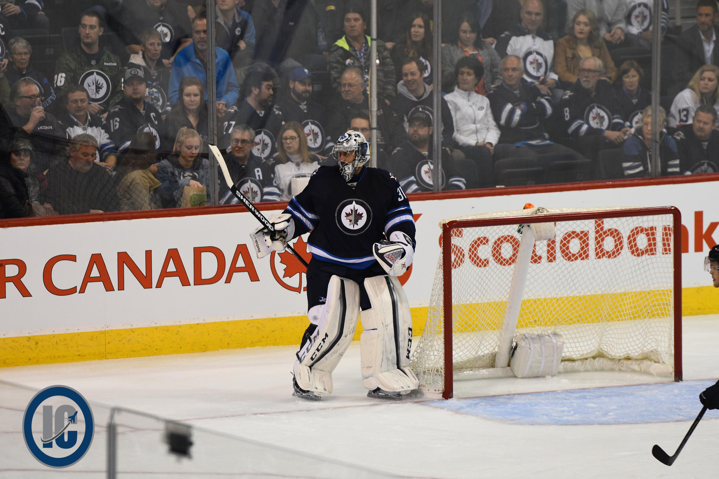 Pavelec clears the puck