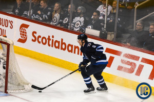Trouba behind the net with puck