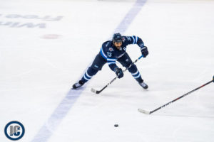 Dustin Byfuglien makes a pass