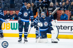 Byfuglien and Hellebuyck share a laugh