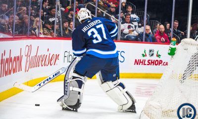 Connor Hellebuyck plays puck