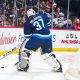 Connor Hellebuyck plays puck