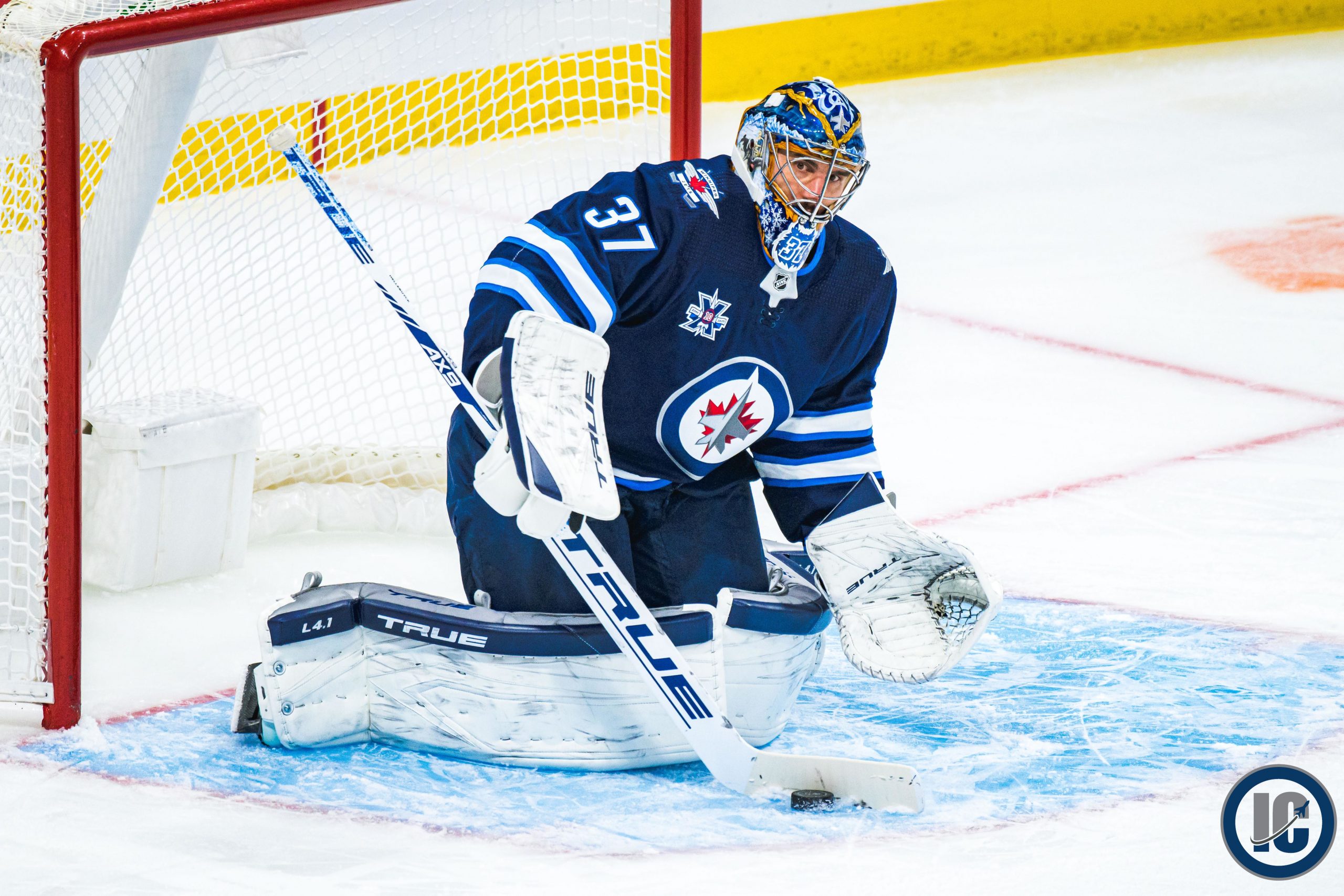 Connor Hellebuyck playing puck scaled