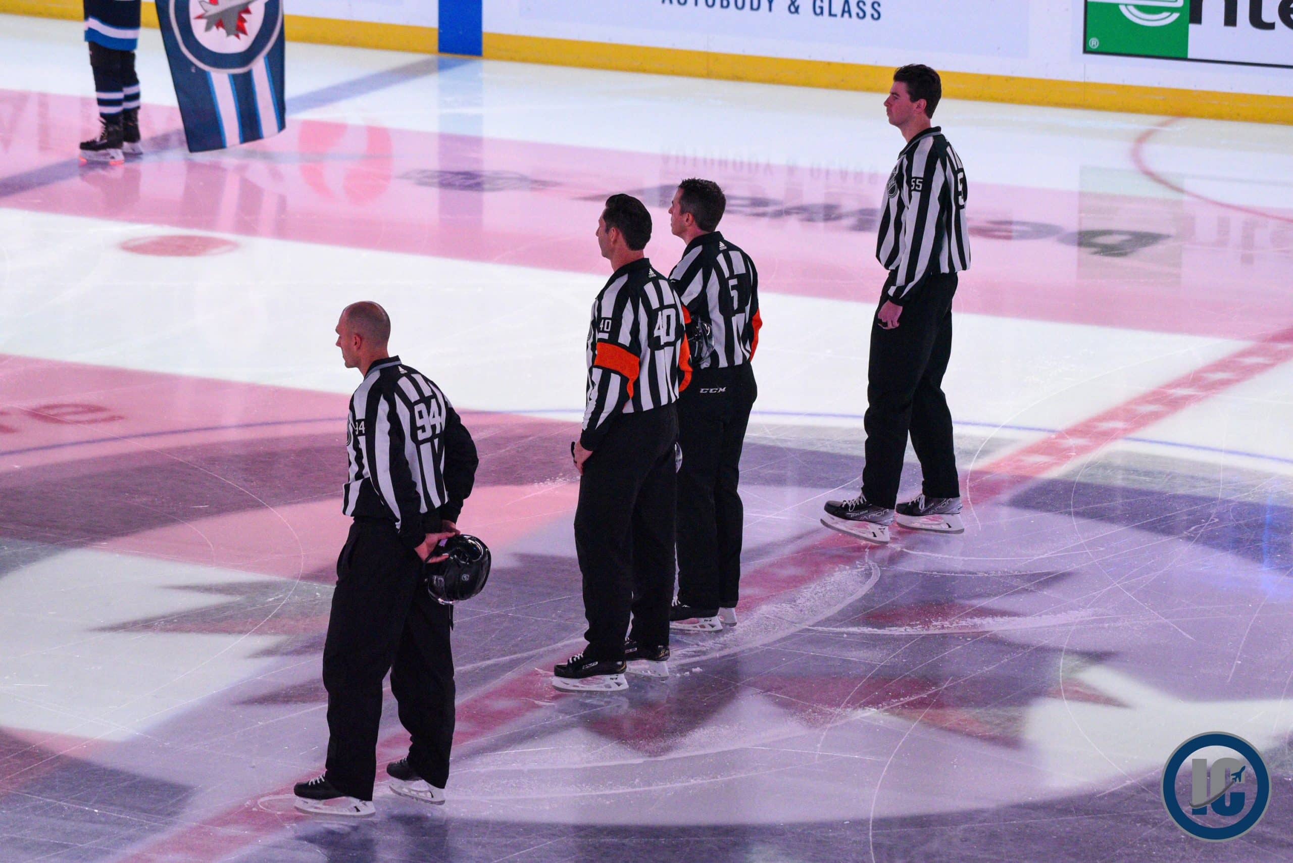 Refs at centre ice scaled