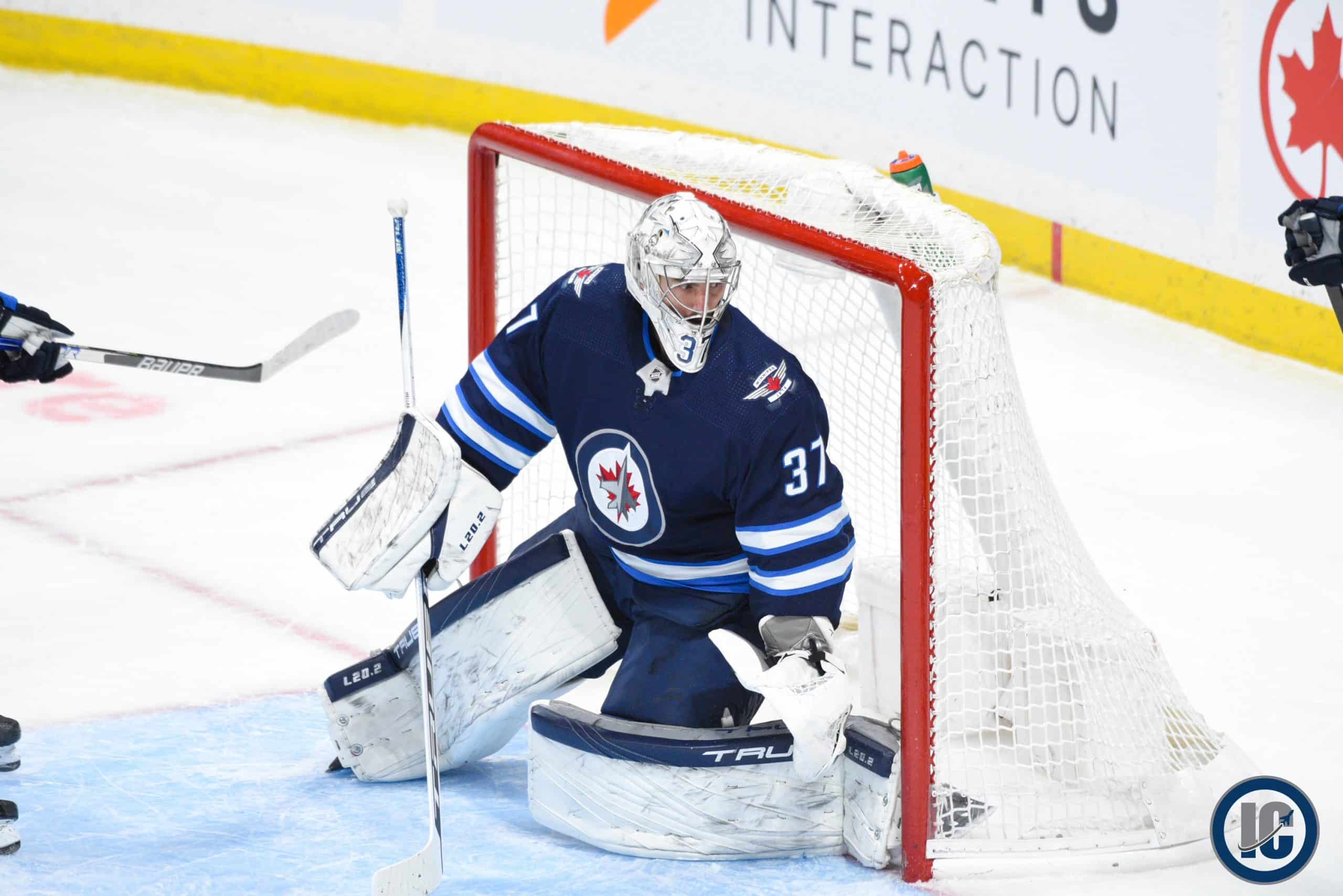 Connor Hellebuyck sliding across scaled