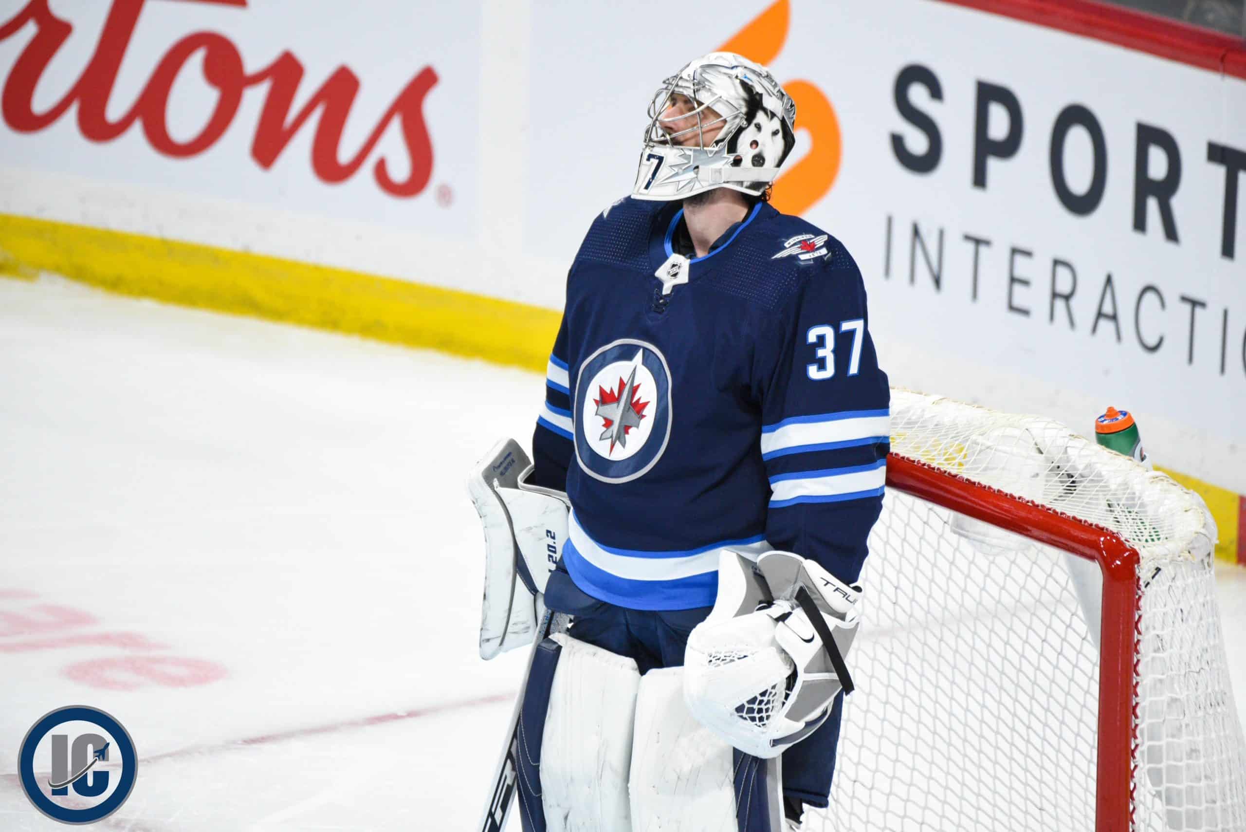 Hellebuyck looking up at scoreboard scaled