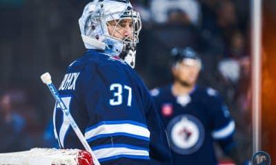 Connor Hellebuyck looking right